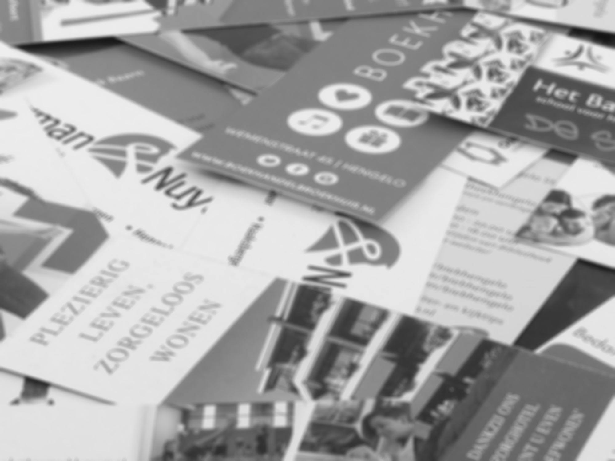 Black and white image of print materials, such as fliers and brochures, text in german