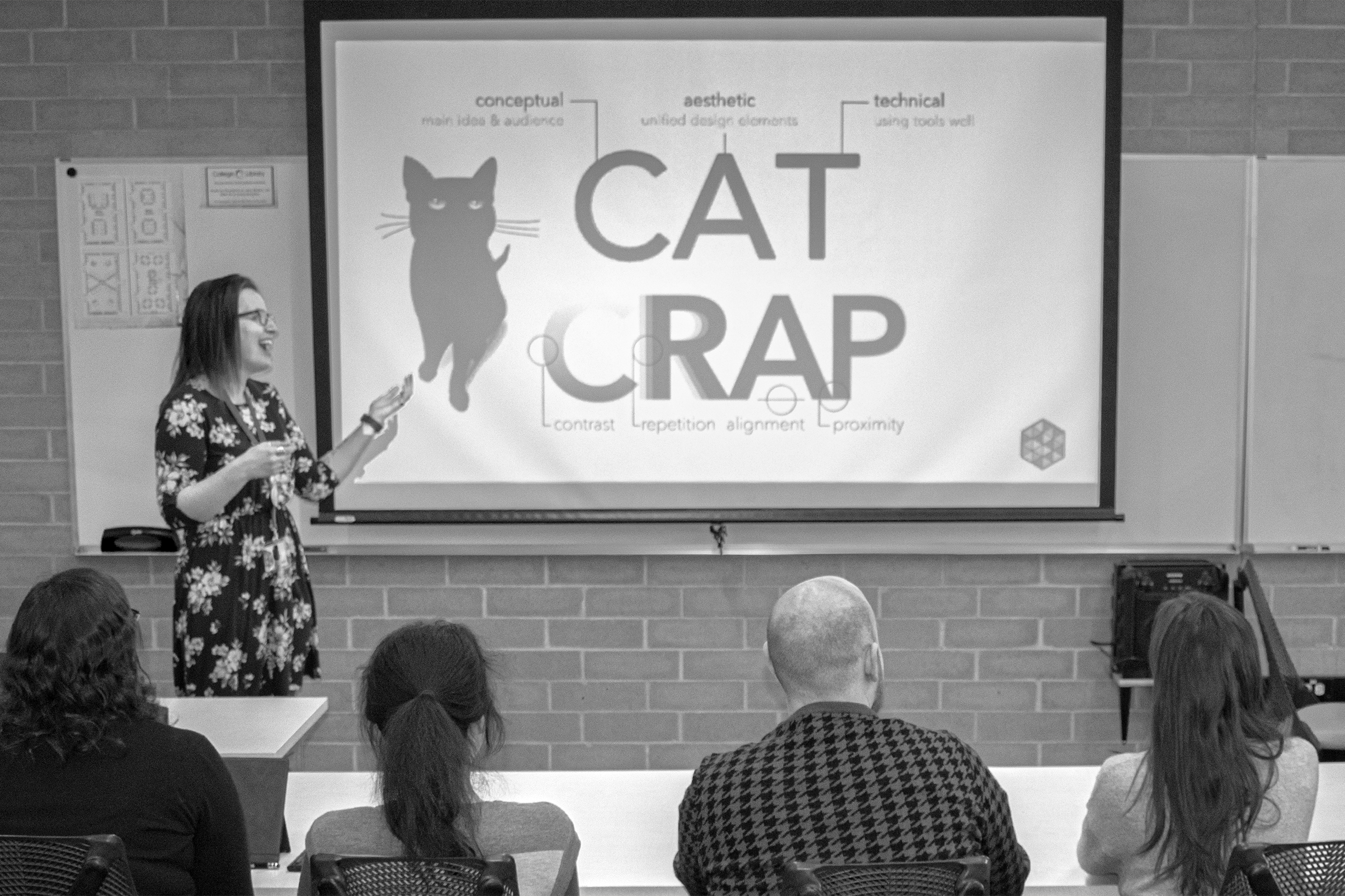 DesignLab staff member Molly teaching design principles to students in a classroom.