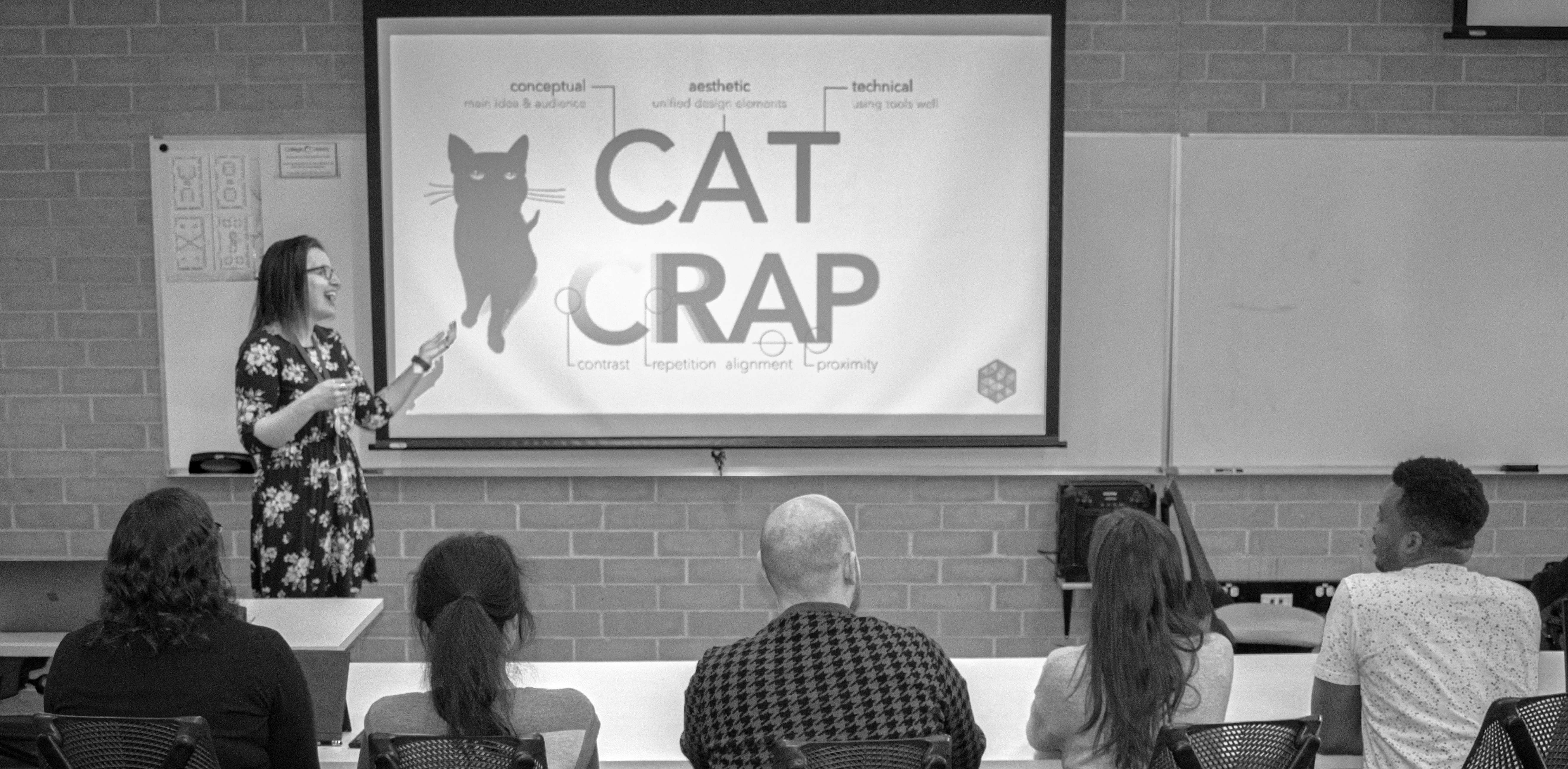 DesignLab staff member Molly teaching design principles to students in a classroom.